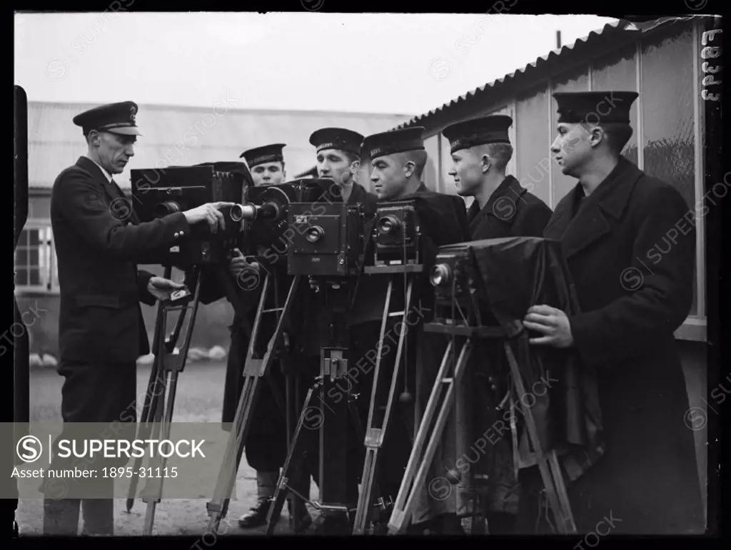 A photograph of trainees at the Royal Naval School of Photography, taken by Reuben Saidman for the Daily Herald newspaper on 16 February 1938. The sch...