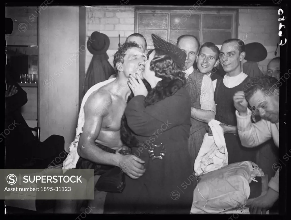 A photograph of boxer Eddie Phillips receiving a winner´s kiss after his successful fight against Arno Kolblin, taken by Edward Malindine for the Dail...