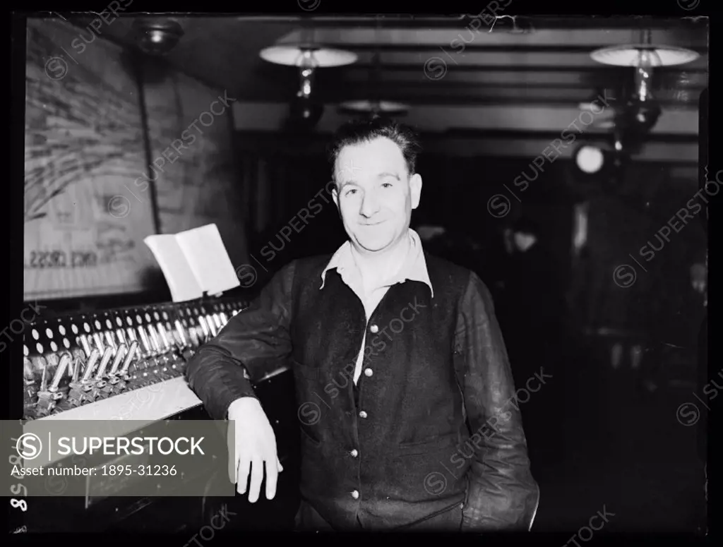 A photograph of signalman Bob Webster, taken by Roper for the Daily Herald newspaper on 19 December, 1939.   Mr Webster leans against the control pane...
