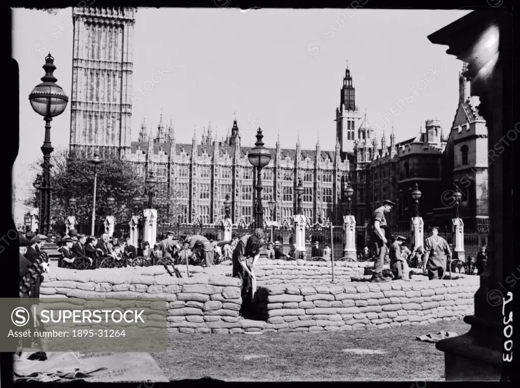 A photograph of people building sandbag defences in central London, near the Houses of Parliament, taken by Roper for the Daily Herald newspaper on 20...