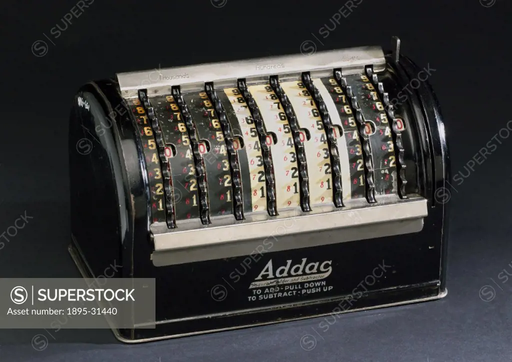Machine marked for American currency with finger-operated wheels. Used for quick calculations in the office or shop.