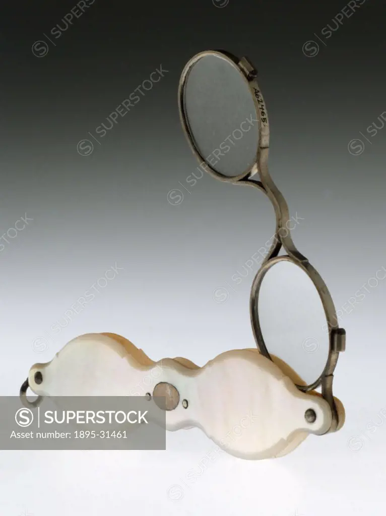 Silver framed spectacles with a mother of pearl fold away handle. Spectacles to correct sight were an established product by this time. Then, as now, ...