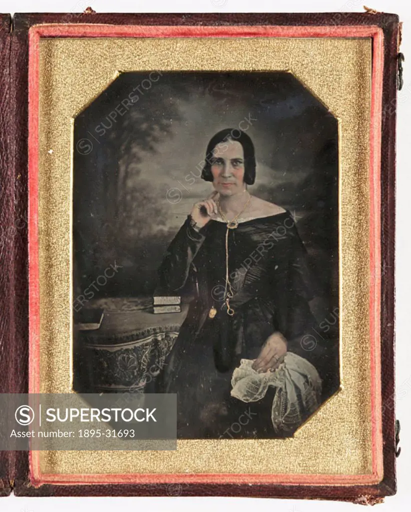 A hand-coloured daguerreotype portrait of a woman, taken by an unknown photographer in about 1845. The colour has been rather liberally applied to her...