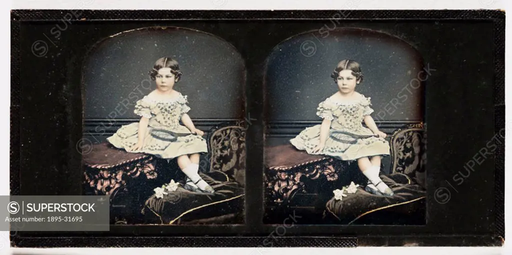 A hand-coloured stereoscopic daguerreotype portrait of a young girl holding a tennis racket, taken by Thomas Richard Williams in about 1855. WIlliams ...