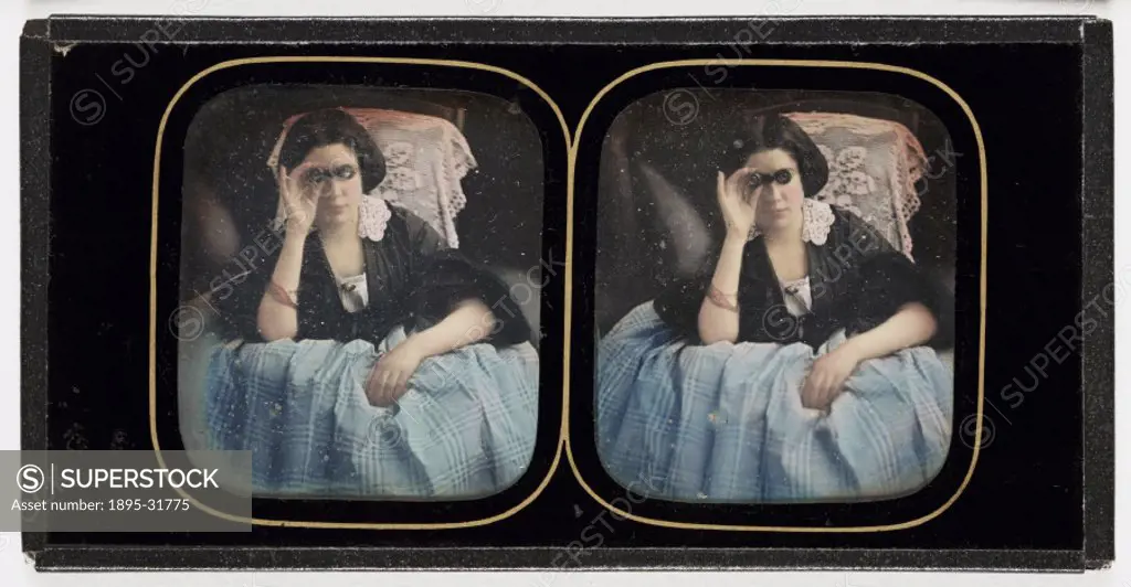 A hand-coloured stereoscopic daguerreotype of a young woman holding a pair of opera glasses, taken by an unknown photographer, in about 1855.  In 1832...