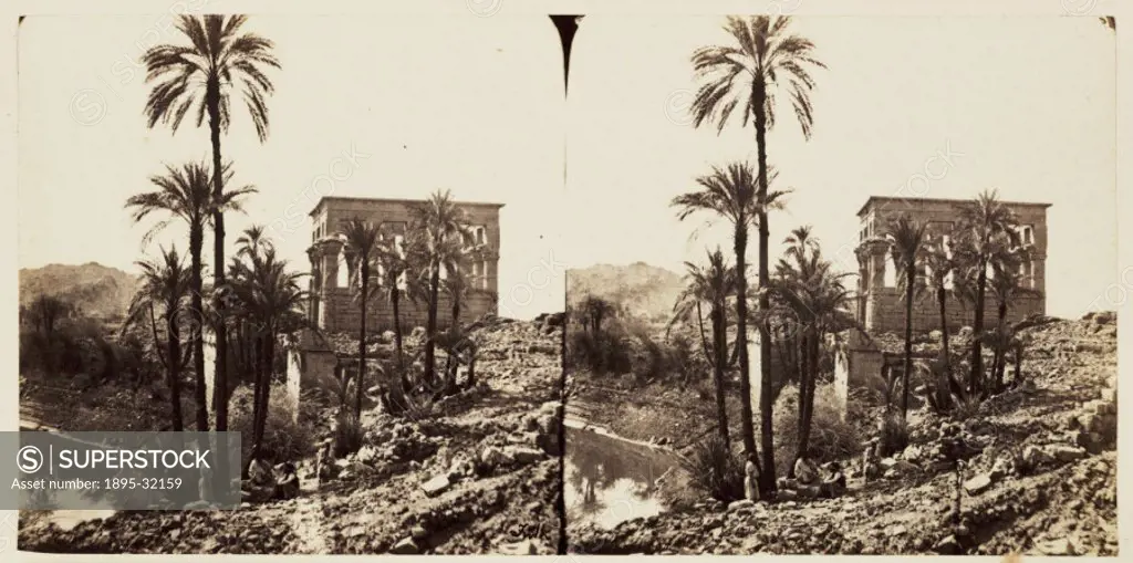 A stereoscopic photograph of the small temple of Hathor seen beyond palm trees on the island of Philae, Aswan, Egypt, taken in 1859 by Francis Frith (...