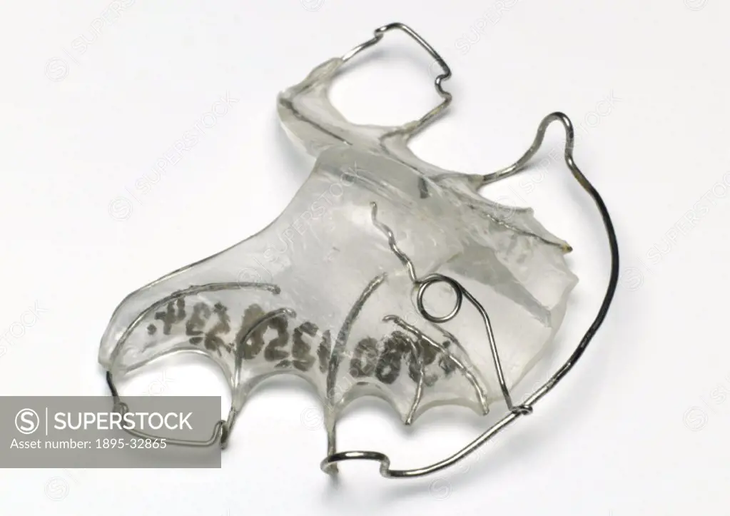 One of eight removable upper braces constructed from clear acrylic plates and stainless steel wire. Part of a collection of dental equipment from the ...