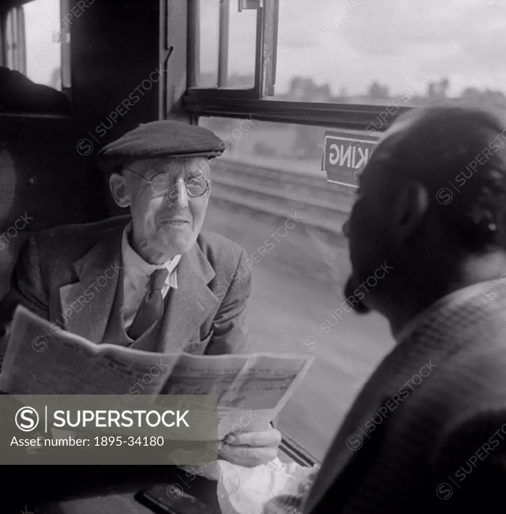 Old man and Colin Wills talking during their journey on an express train from Leicester to St Pancas. Photograph taken during the making of the Britis...