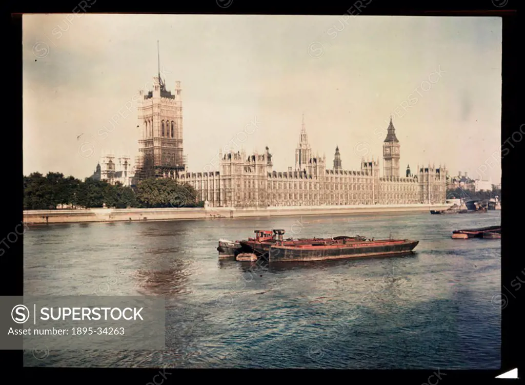 A Dufaycolor colour transparency of barges on the River Thames in front of the Houses of Parliament, taken by an unknown photographer in about 1945. A...