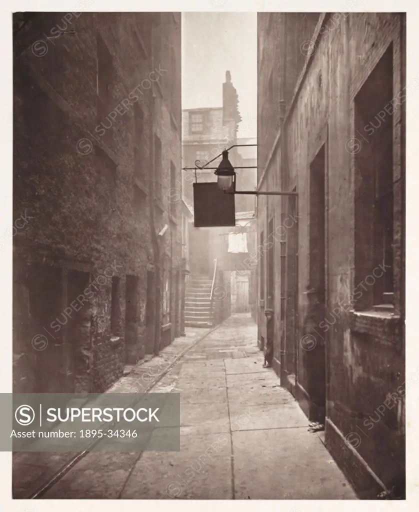A photograph of a close behind No. 18 Saltmarket in Glasgow, taken by Thomas Annan (1829-1887), in 1868.  Saltmarket Street crosses the High Street in...