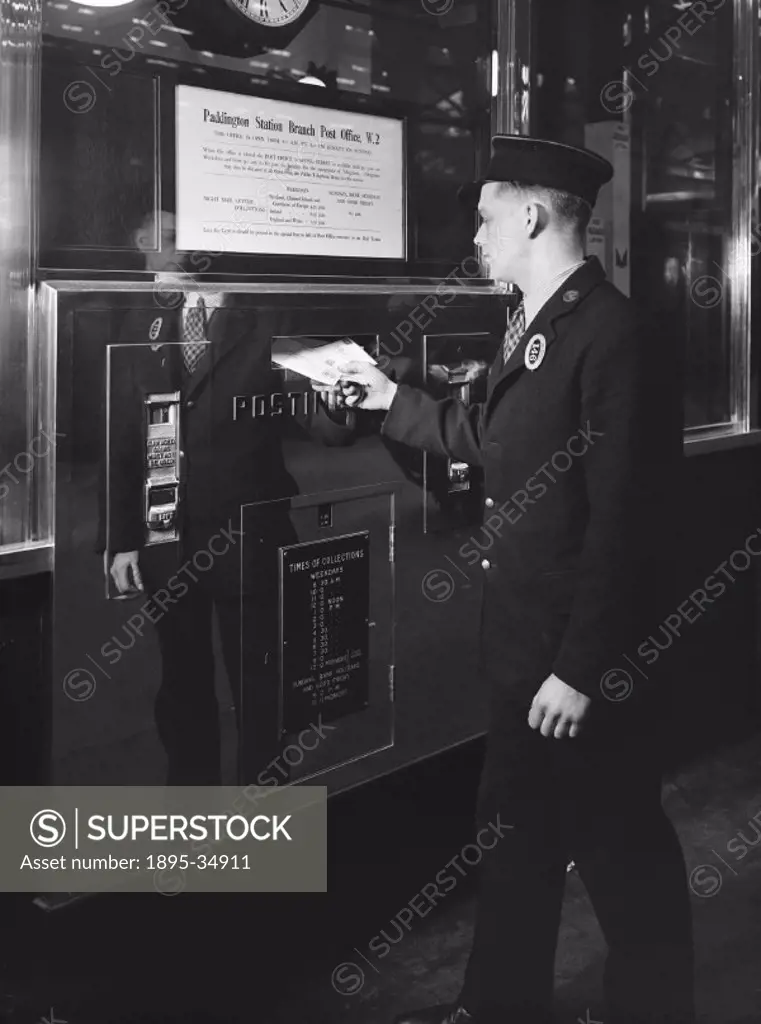 Railway worker posting a letter at Paddington station, London, 1936.   The railways had always carried parcels and letters, and it made sense for peop...