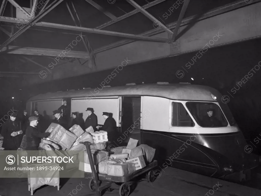 A diesel railcar being unloaded at Paddington station parcel depot, December 1936.   Parcel depots were especially active at night. Parcels were often...