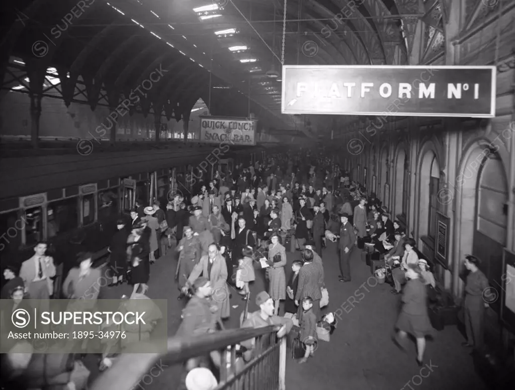 Crowds at Paddington Station, at 9.08 am, 7 August 1943.  The passengers were going out for the day as it was Bank Holiday.   During the war many publ...