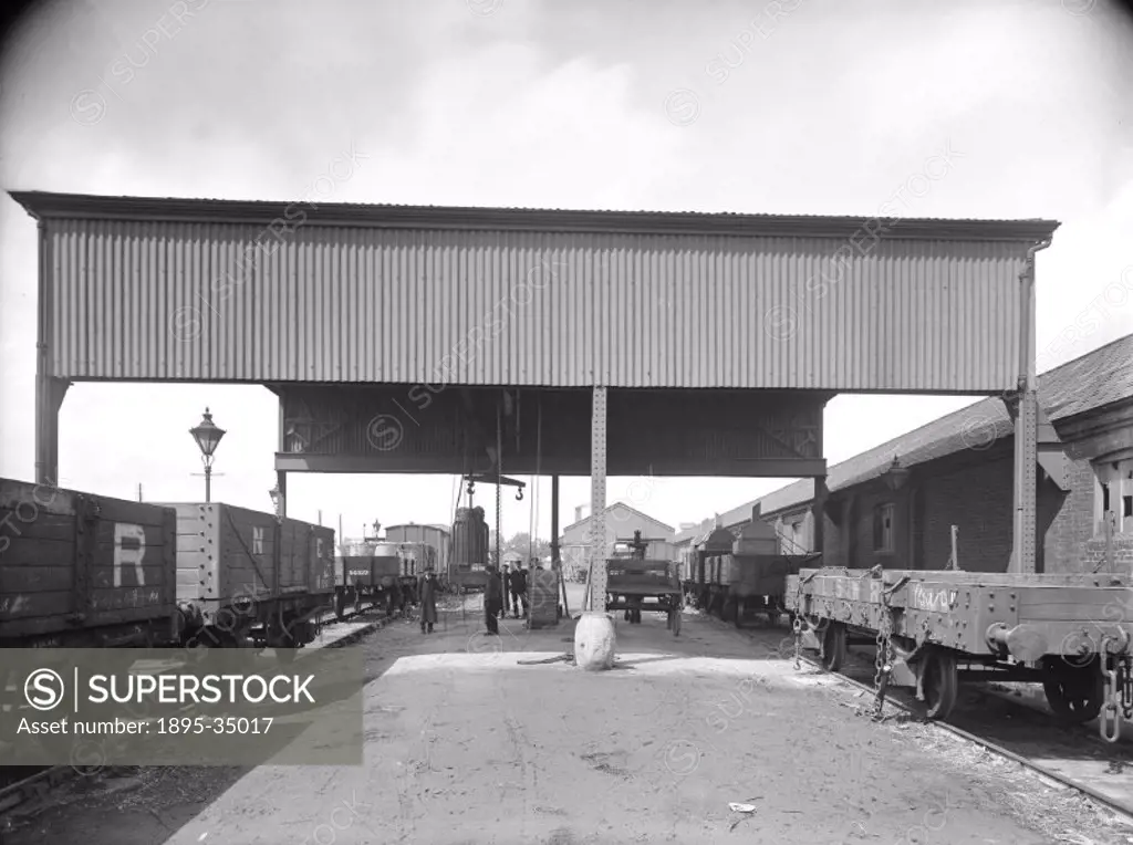 A gantry crane at a Great Western Railway goods yard, about 1917. This crane was used for moving freight on and off wagons in railway goods yards.   T...