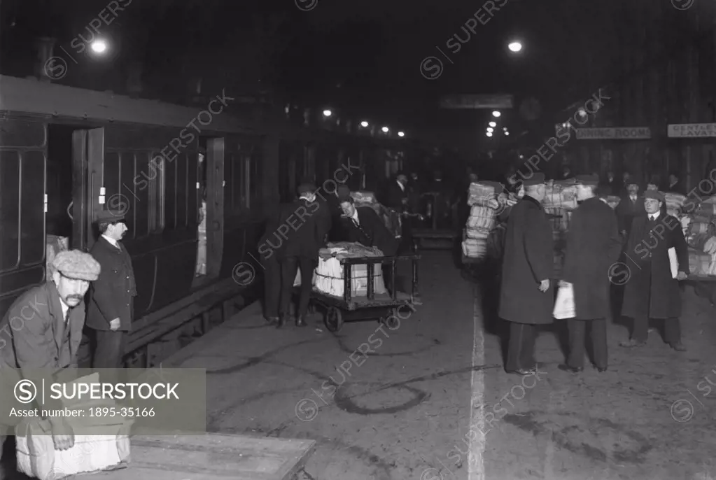 Newspapers being loaded onto a train at Paddington station, about 1910.   By the 1900s newspapers were being carried from the printers to their destin...