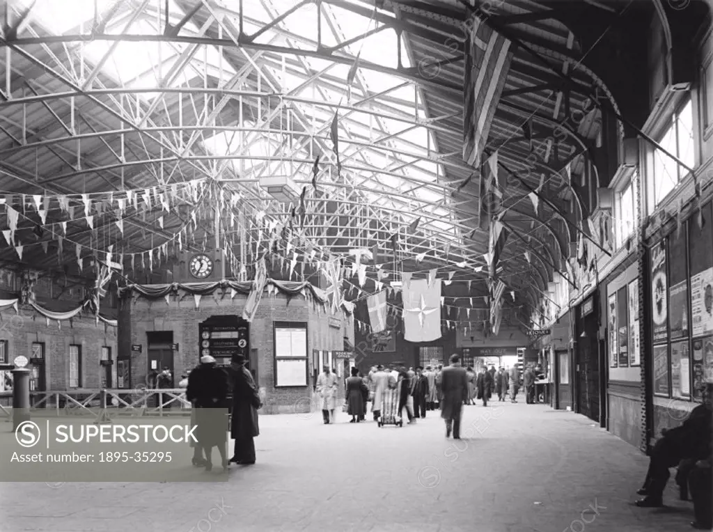 Inside Tilbury Riverside station, Essex, 16 May 1950. The station is decorated with flags, for a celebration, or for a Royal visit.  This station open...