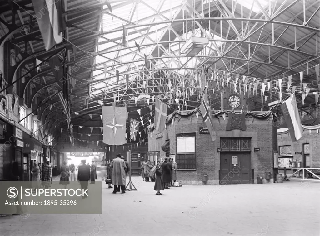 Inside Tilbury Riverside station, Essex, 16 May 1950. The station is decorated with flags, for a celebration, or for a Royal visit.  This station open...