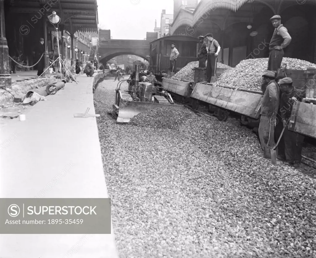 Workers putting ballast in place at Stoke Newington, London, 20 April 1958. Many miles of track were relaid in the 1950s and 1960s, to strengthen it b...