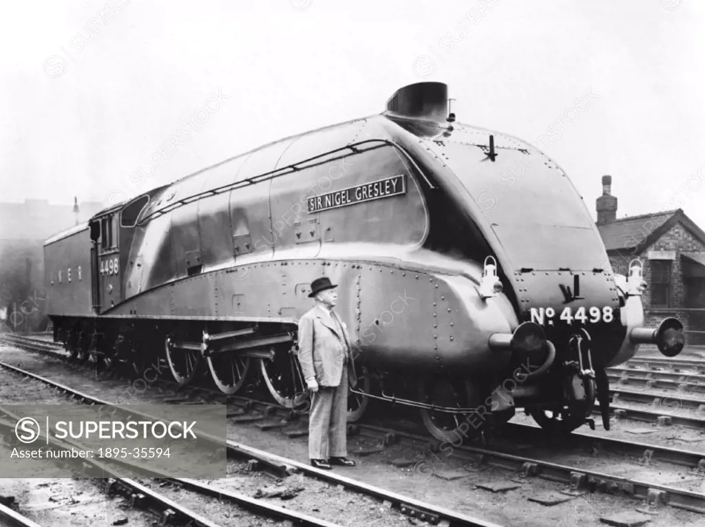 An A4 class 4-6-2 locomotive number 4498 ´Sir Nigel Gresley´, 1937. Sir Nigel Gresley, the designer of the locomotive, is standing next to it.  This s...