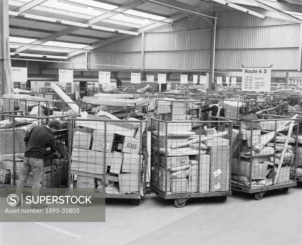 Inside a parcel terminal, Peterborough, Cambridgeshire, 24 July 1970.   These parcels have been sorted as to their destination and put on the correct ...
