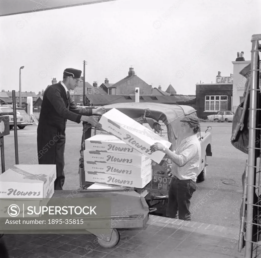 Boxes of flowers being unloaded from a lorry onto a trolley at Yarmouth, 1971. Flowers could be moved around the country quickly by rail, and the cont...