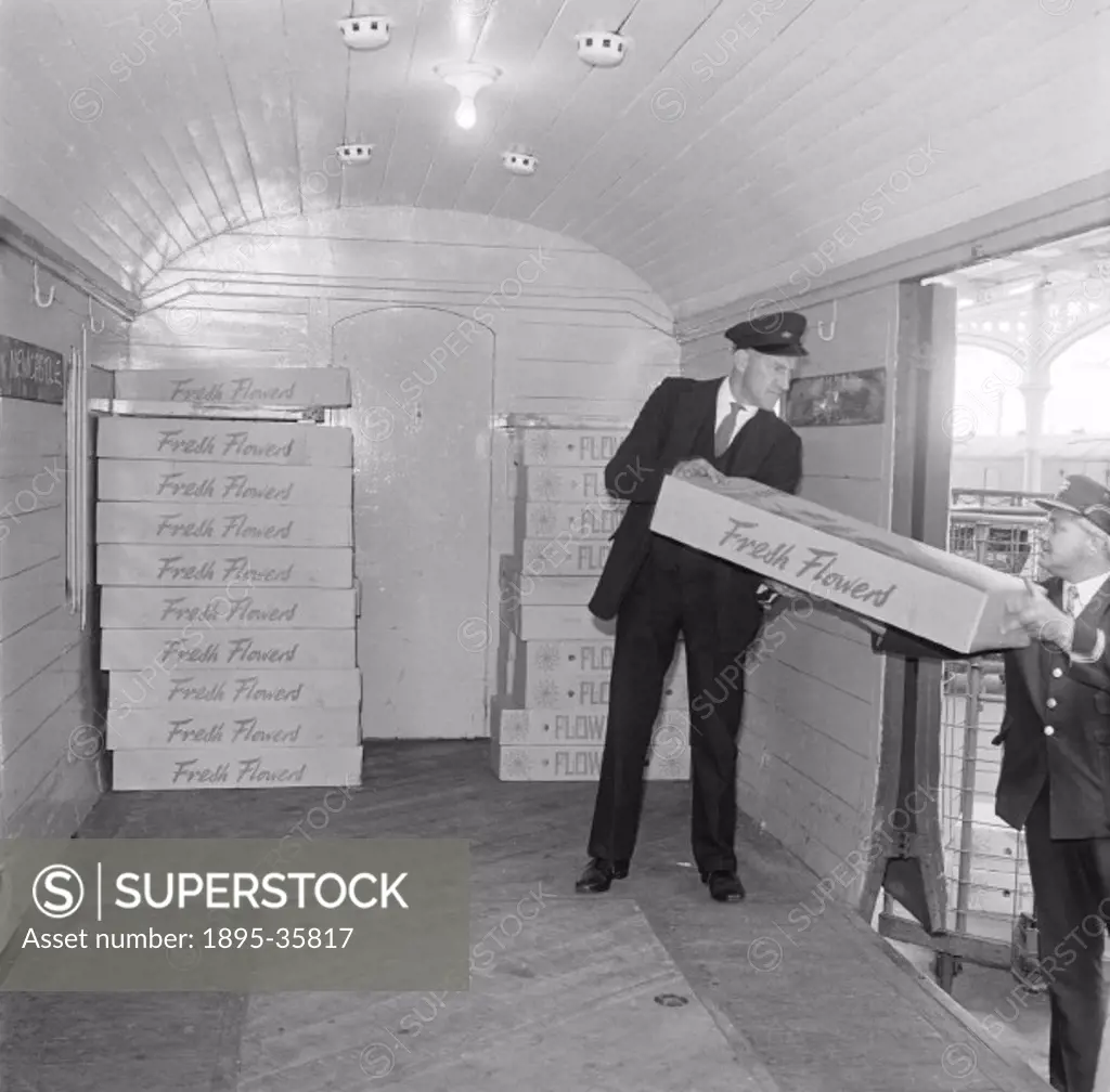 Boxes of flowers being loaded into a container at Yarmouth, Norfolk, 1971. Flowers could be moved around the country quickly by rail, and the containe...