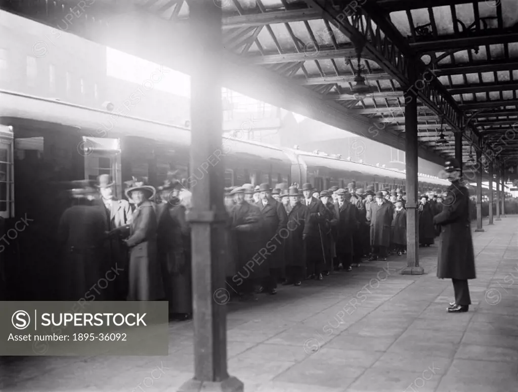 Queues of people waiting to see an ambulance train at Huddersfield station, West Yorkshire, 1916.  Ambulance trains were used during the First World W...