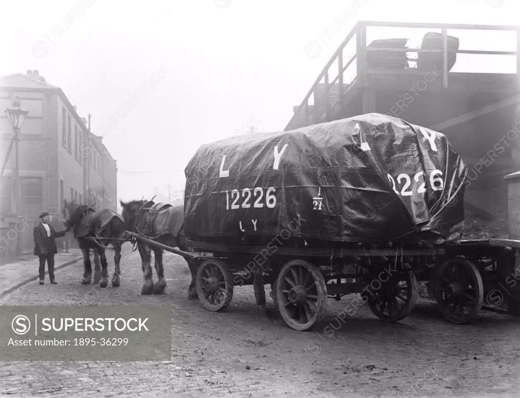 Trolley, pulled by two horses in a Lancashire & Yorkshire Railway goods yard, 3 February 1921. These horses were used in goods yards to transport frei...