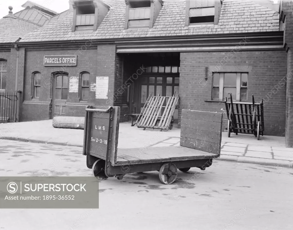 Platform trolley at the parcel office at Barrow station, Cumbria, 11 February 1930.  These trolleys transported goods from the parcel office, where th...
