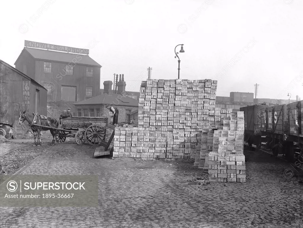 St Pancras goods yard, London, 1933.Bricks being loaded onto a horse_drawn cart at St Pancras Station goods yard. The railway companies often provided...