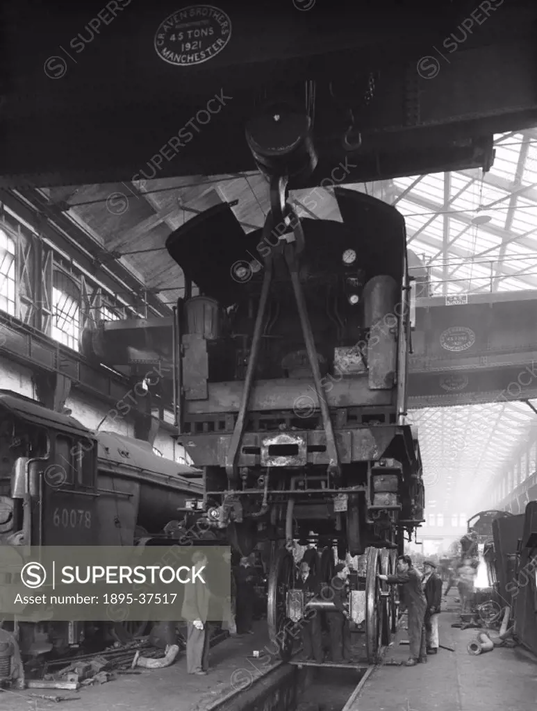 Workers repairing locomotives at Doncaster works, 7 October 1952.  Doncaster works, known as the ´Plant Works´ opened in 1853, making and repairing lo...
