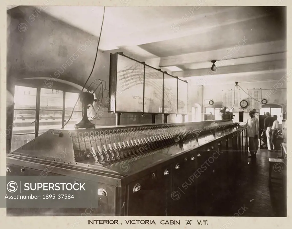 Interior of a signal box at Victoria Terminus, Bombay, (now Mumbai). The lever frame moved the points to set the route for trains, and at the same tim...