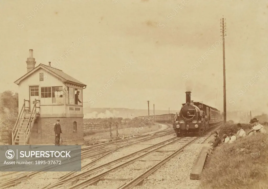 Passenger train, pulled by a broad gauge 2-2-2 locomotive, at Uphill Junction, Somerset, by the Reverend A H Malan, about 1865. This junction is on th...