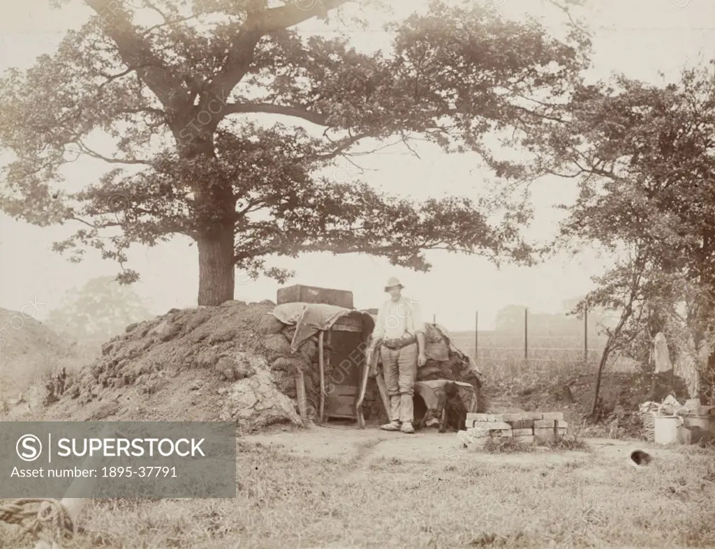 Worker on the Harrow to Uxbridge line, about 1902.   The small turf shelter might have been used to store tools, or as a rudimentary canteen. In the n...