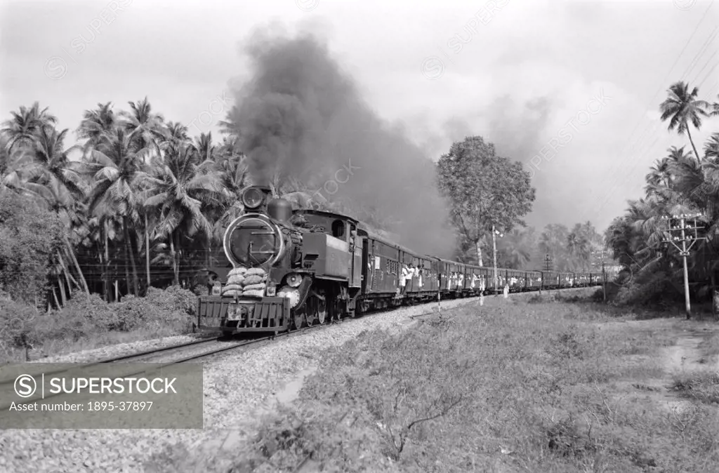 Passenger train at Trichy, India, by Peter Bawcutt, 1969.  To cope with India´s varied terrain, the Indian Railways used three gauges: 2´ 6´´, metre g...
