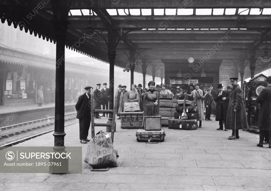 Male and female porters with luggage on a station platform, about 1918.  During the First World War many male workers joined the army, so women were e...