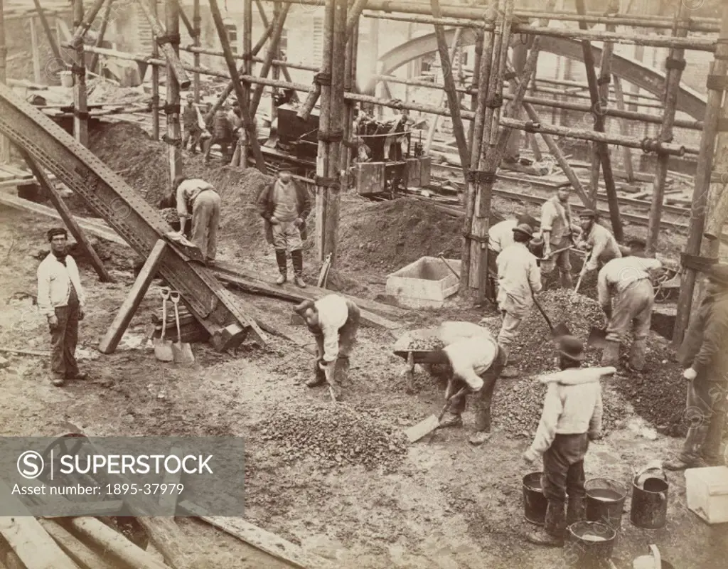 Navvies mixing concrete during the construction of the underground Metropolitan Railway, by Henry Flather, about 1861.The workers are being watched by...