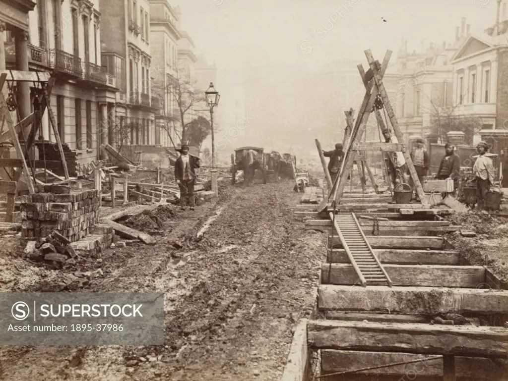Navvies building a railway cutting in a London street, about 1861.   The Railway´s construction caused great disruption in London´s streets, as the ra...
