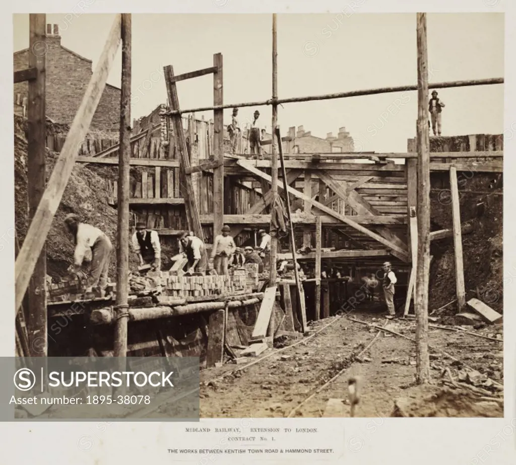 Bricklayers building a retaining wall between Kentish Town and Hammond Street on the Midland Railway, 29 August 1865. The wall was necessary to stop t...