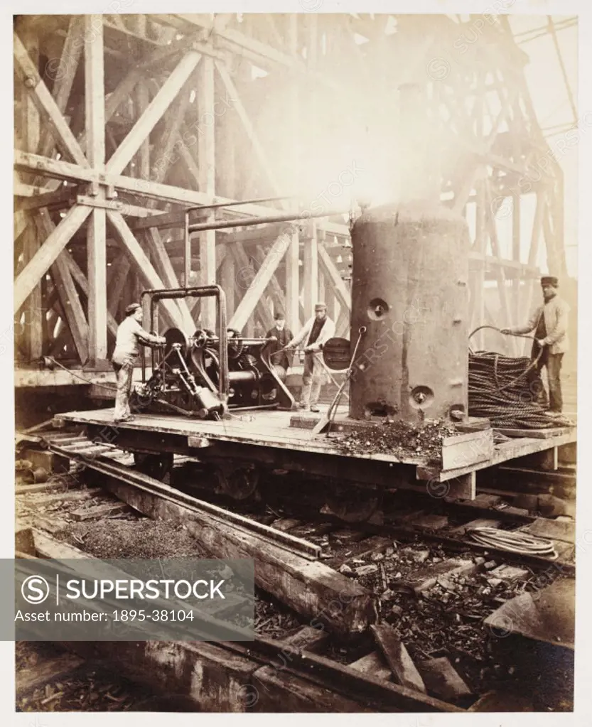 Steam powered winch at St Pancras station, by J B Pyne, about 1867. This winch was used to move construction materials and scaffolding up and down dur...