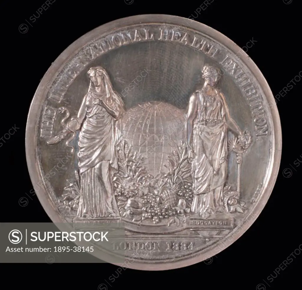 Circular silver medal made in commemoration of the International Health Exhibition held in London. The medal shows the two allegorical figures of Heal...