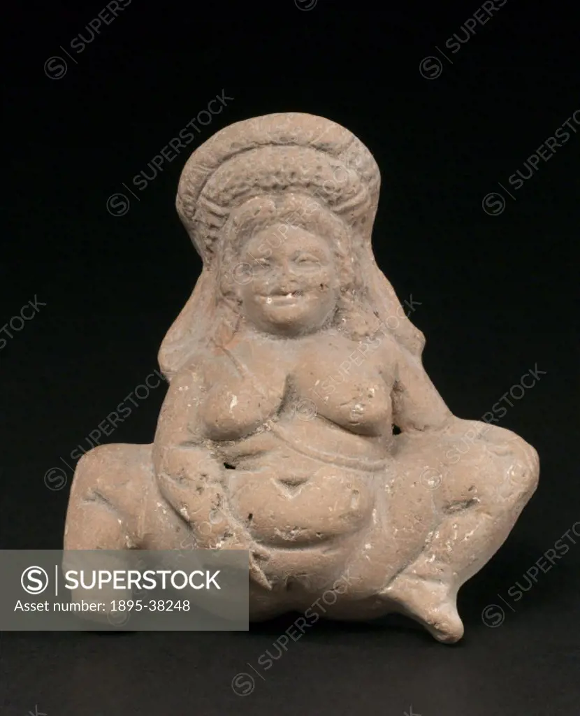 Hollow unglazed terracotta female fertility figure squatting and masturbating.