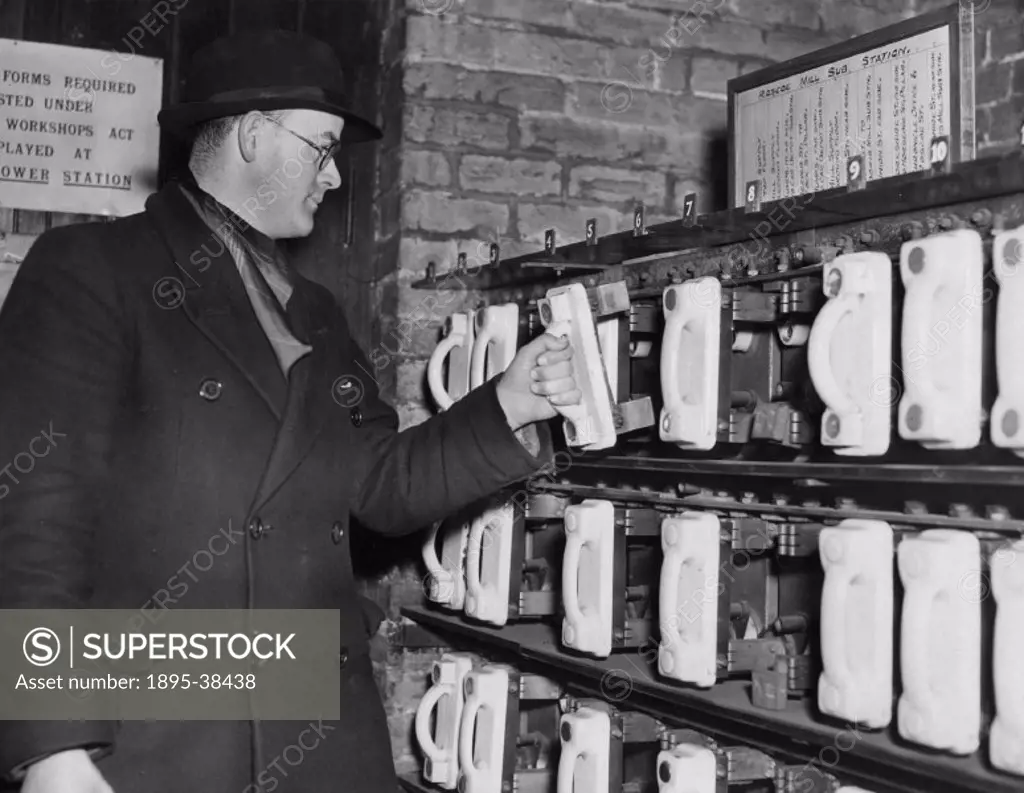 Man removing one of 24 fuses at the Roscoe Mill substation (possibly in Merseyside).