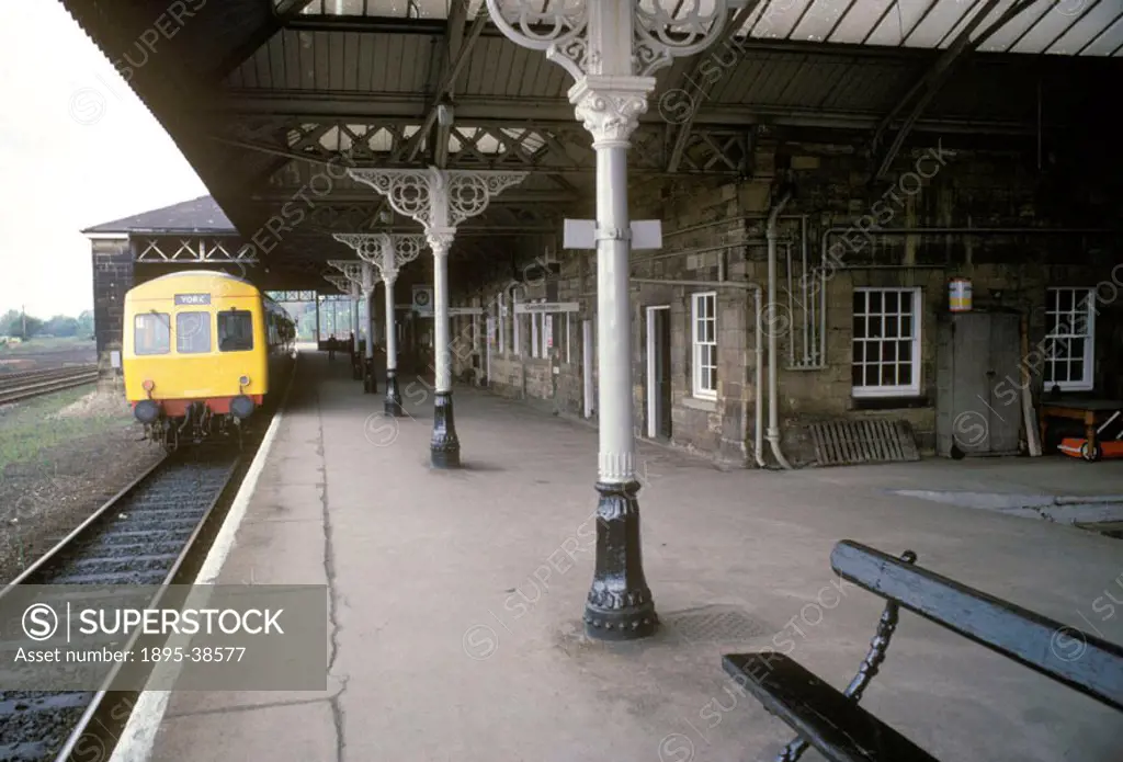 Platform at Malton Station, by Chris Hogg, 1981. A train to York waits at the platform. This line opened in 1845. It is widely used by day trippers vi...