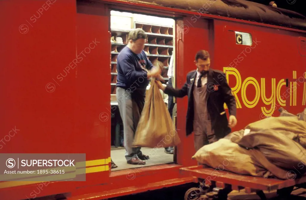 Mail sacks being loaded onto a Post Office train at Newcastle station, by Chris Hogg, 14 September 1987. The mail is being delivered to St Pancras Sta...