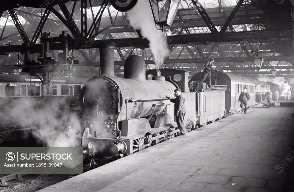 Passenger train, hauled by a locomotive number 8370 at Shrewsbury station, Shropshire, by Cyril Herbert, March 1948.   This locomotive ran on the Lond...