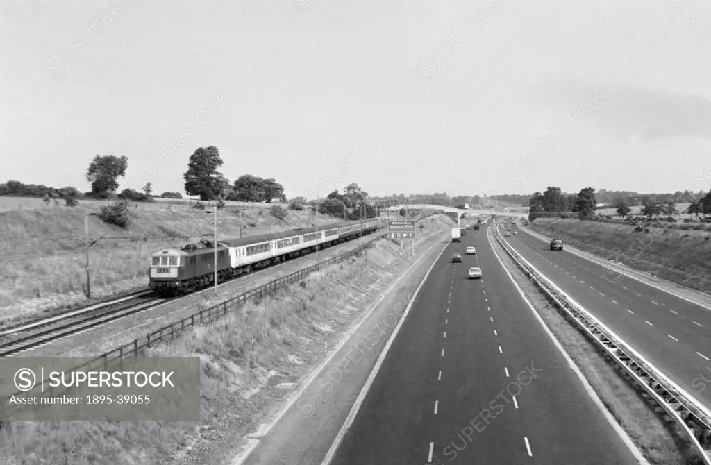 Electric train alongside the M1 at Watford Gap services, by J F Henton, about 1970.  The M1 opened in 1959 between London and Leeds. At this time traf...