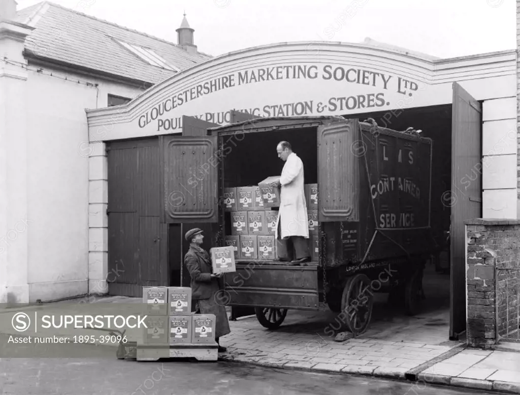 Boxes of eggs being loaded onto a London, Midland & Scottish Railway lorry, at the Gloucestershire Marketing Society´s poultry plucking station, Chelt...