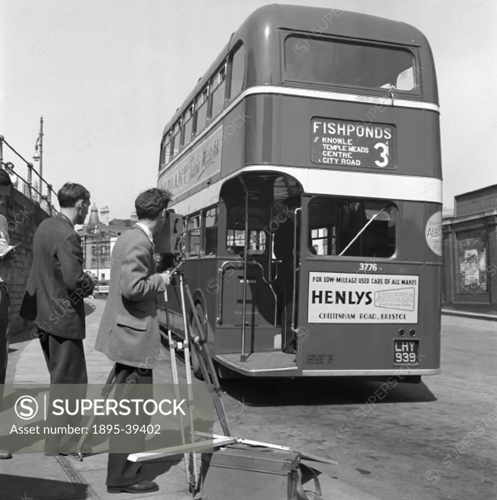 Still photograph taken during the making of the British Transport Films production, Speedup’, showing a cameraman filming one of Bristol bus system’s...