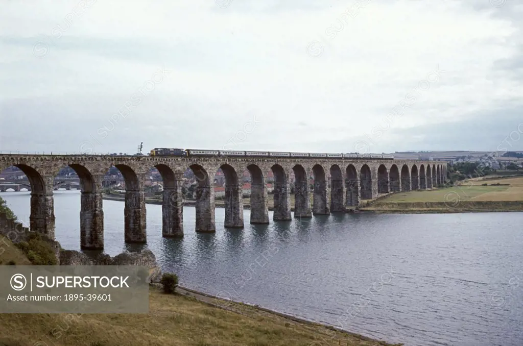 Train passing over the Royal Border Bridge at Berwick upon Tweed, Northumberland, photographed by Eric Treacy, about 1974.  This bridge was designed b...